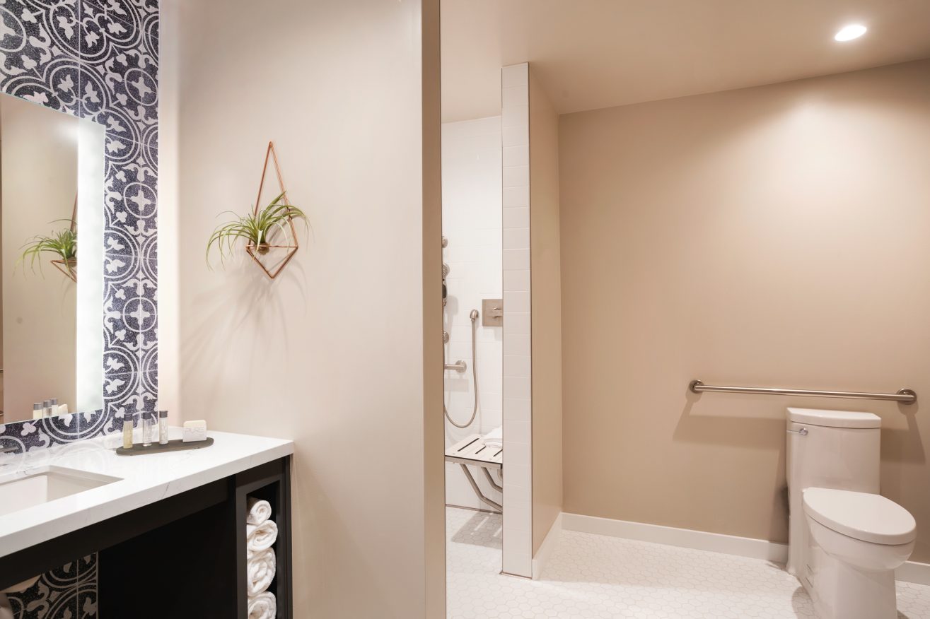 An accessible bathroom with large open spaces and doorways.