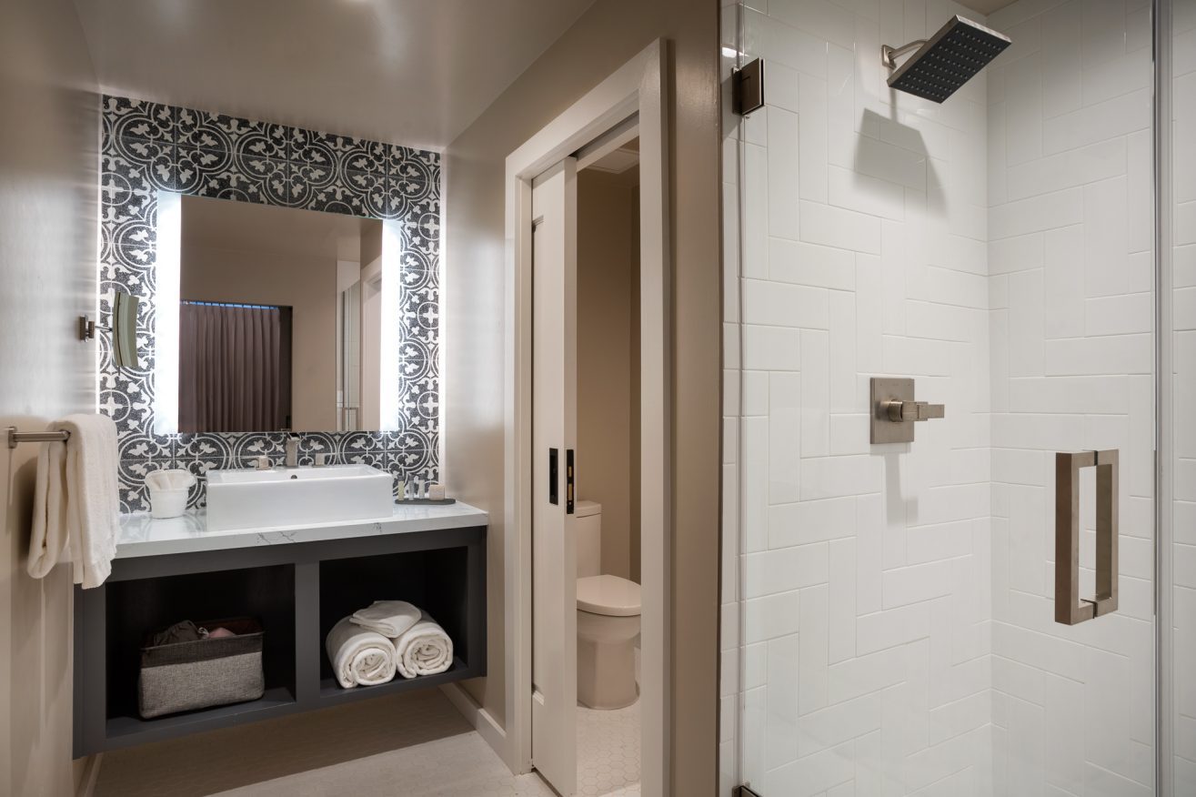 Bathroom with vanity, toilet room and shower.