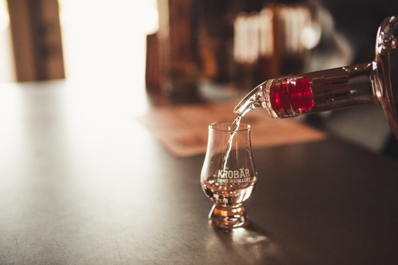 Liquor being poured into a cordial glass